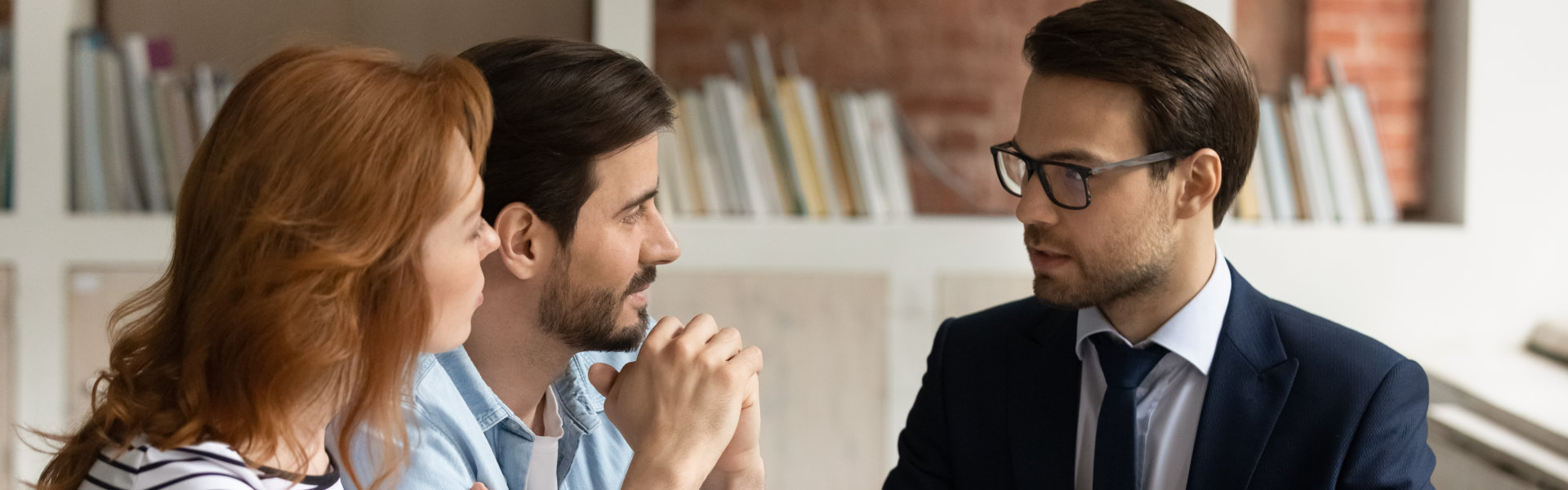 A couple having a discussion with a male lawyer